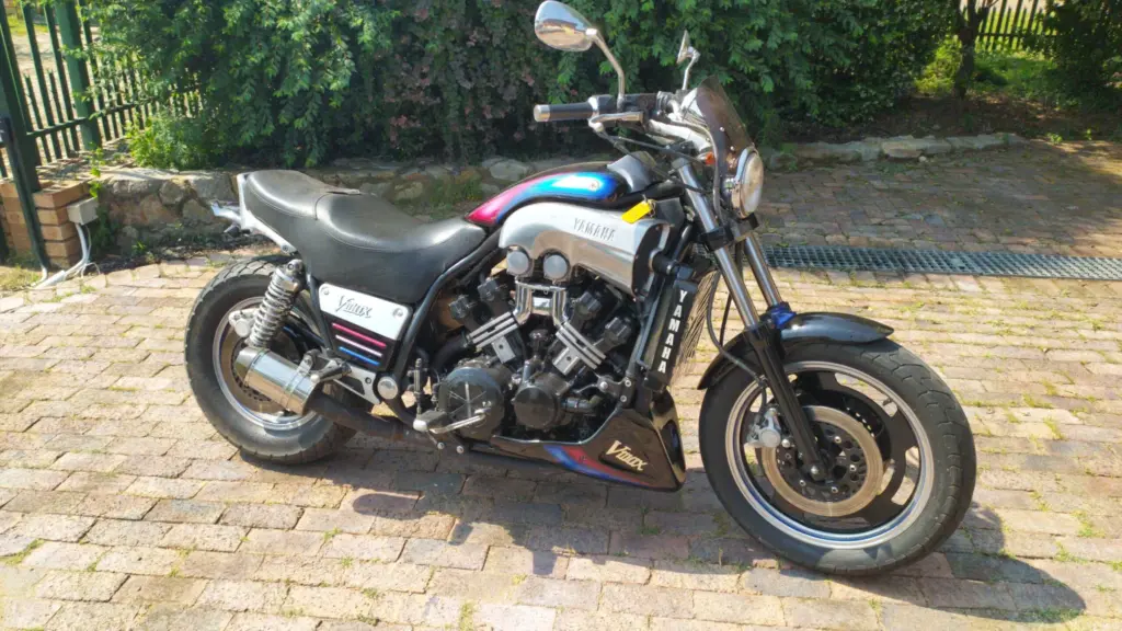 Black Yamaha V-Max parked on a brick driveway