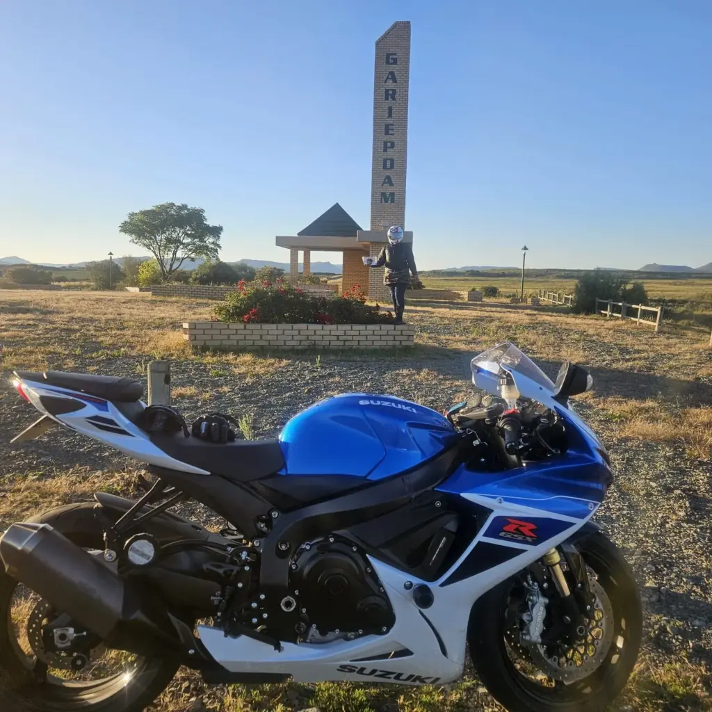 Blue and white Suzuki GSX-R parked at the Gariep Dam monument