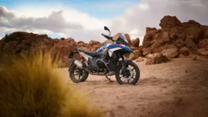 BMW R 1300 GS in GS Trophy colours parked among red rocks