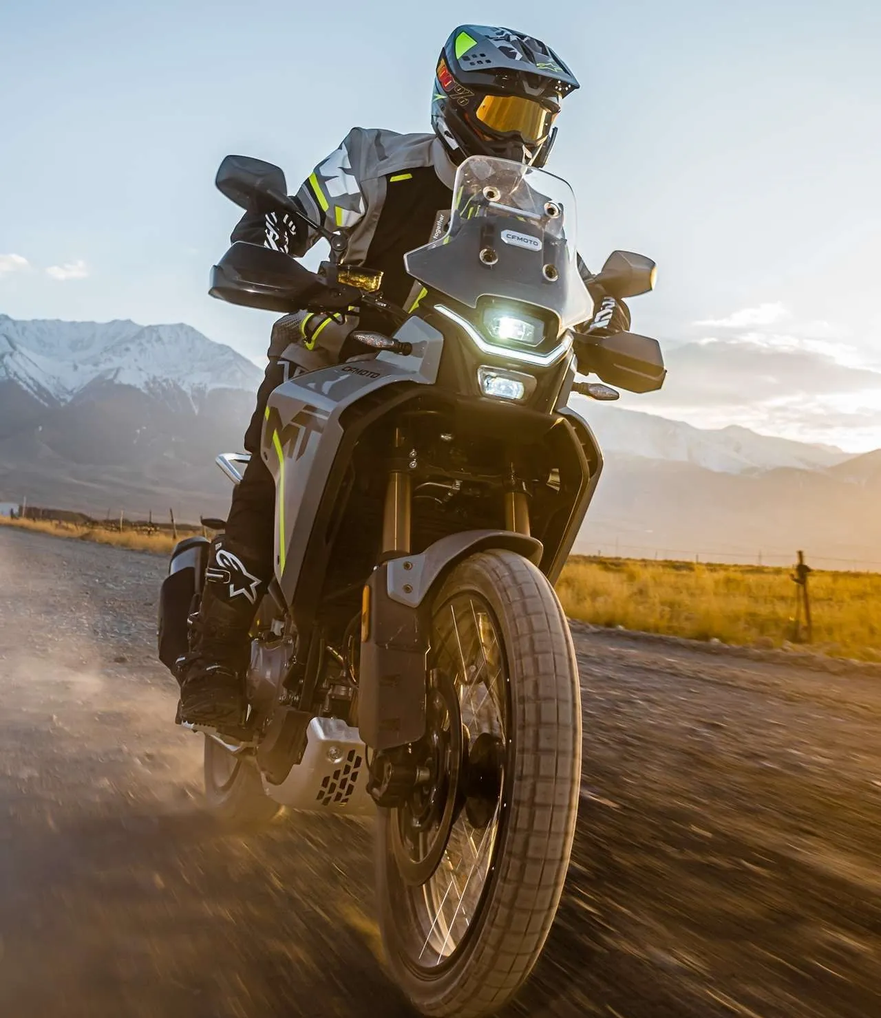 CFMOTO 450MT adventure bike ridden hard on a dirt road at sunset