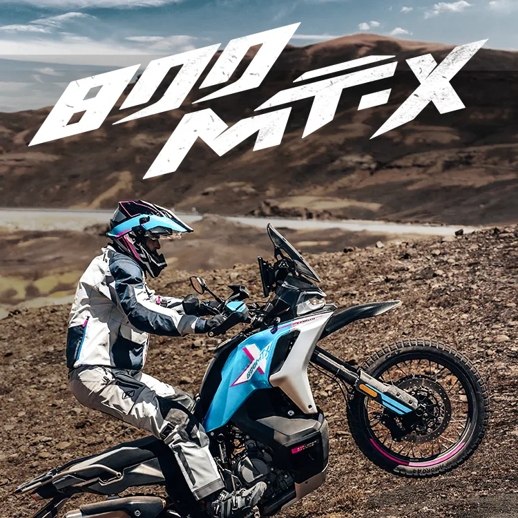 CFMOTO 800MT-X launch artwork with a rider standing on the pegs off-road