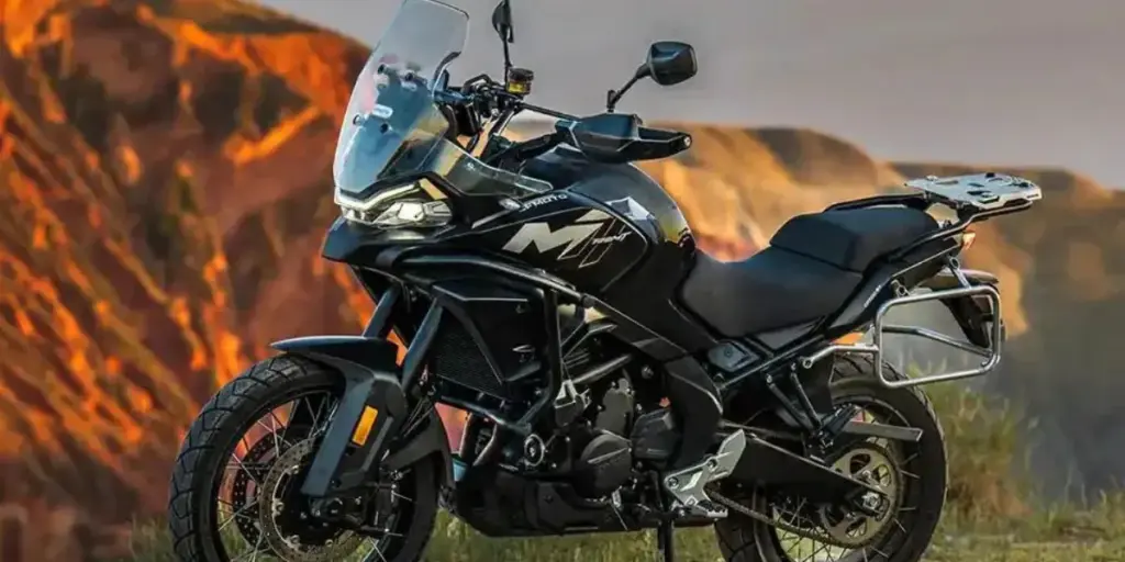 CFMOTO 700MT with panniers parked against red rocks