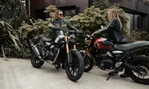 Two riders chatting beside Triumph modern classic motorcycles