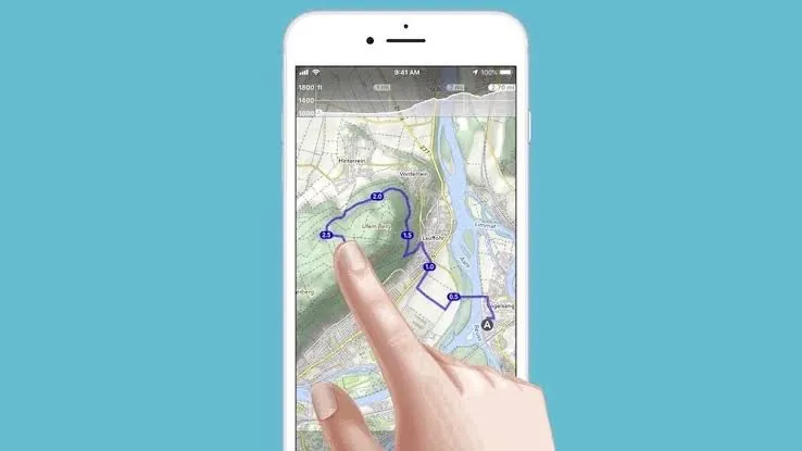 Finger tracing a motorcycle route on a smartphone map app