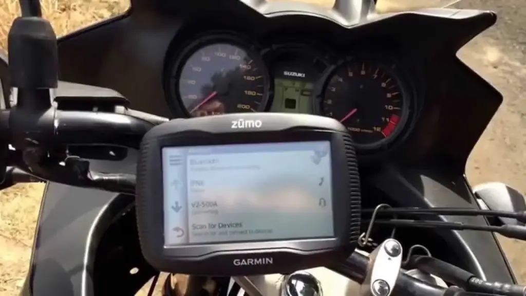Garmin zumo GPS mounted on a motorcycle cockpit beside the dials