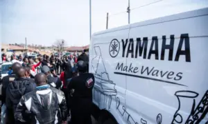 Riders gathering beside a Yamaha van at the Mandela Day charity run