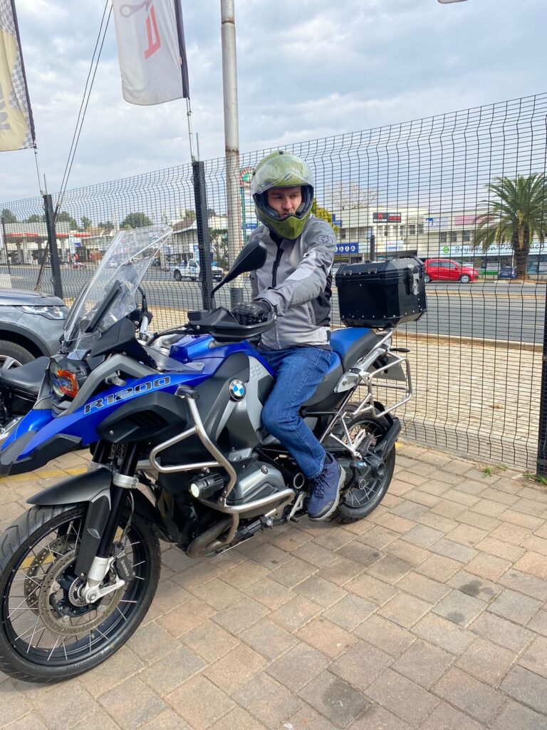 Rider on a blue BMW R 1200 GS Adventure on a town street