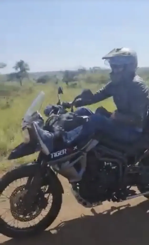 Rider on a Triumph Tiger 800 XCx on a rural dirt road