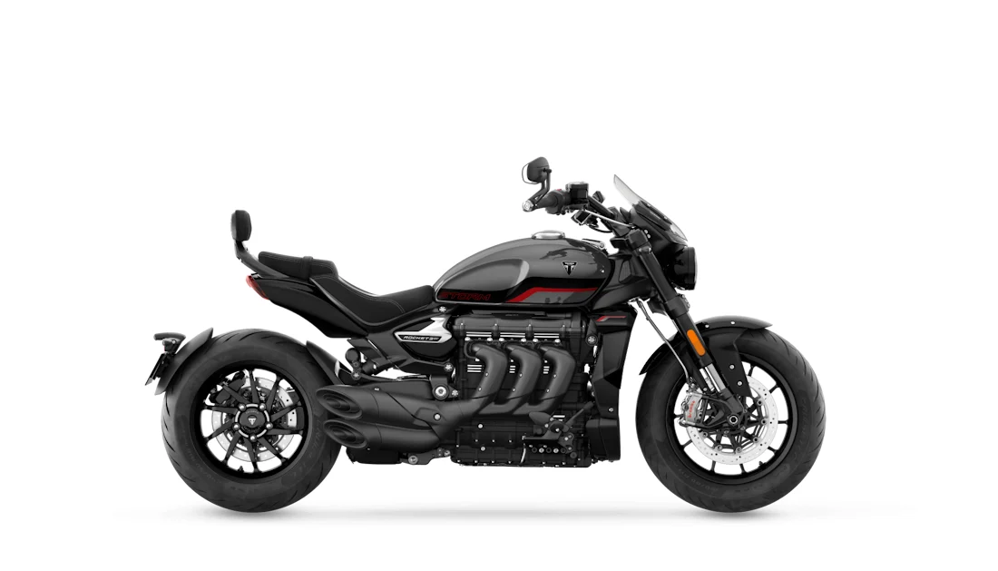 Triumph Rocket 3 Storm GT side view, black and grey with red tank stripes, flyscreen and pillion backrest