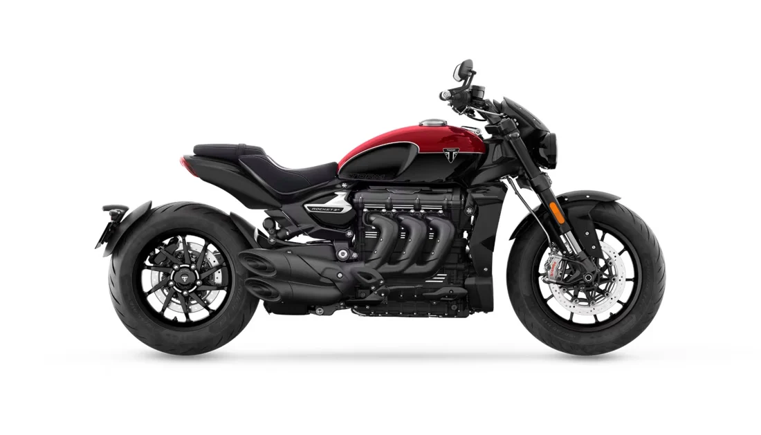 Triumph Rocket 3 Storm R side view, black with a red tank, showing the 2,458 cc triple and exhausts