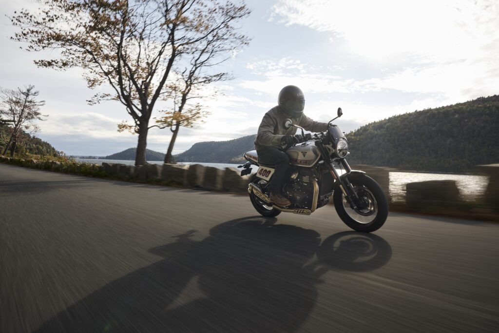 Rider on a Triumph Tracker 400 on a lakeside road