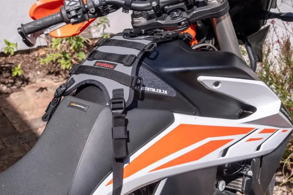 Turkana GeckoGrip harness fitted to the tank of an orange and white KTM
