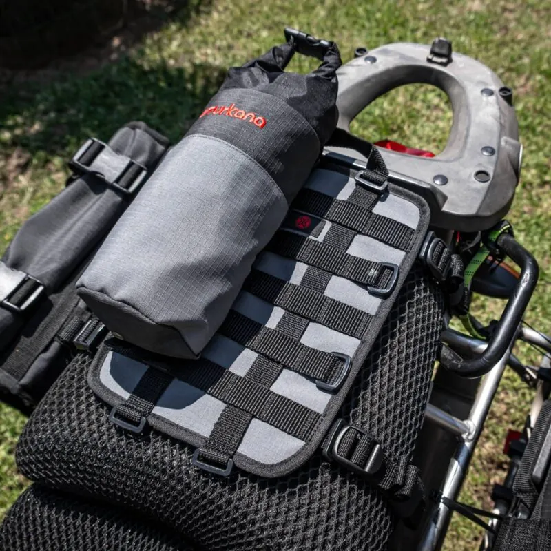 Turkana GeckoGrip harness holding a dry bag on a motorcycle tail rack