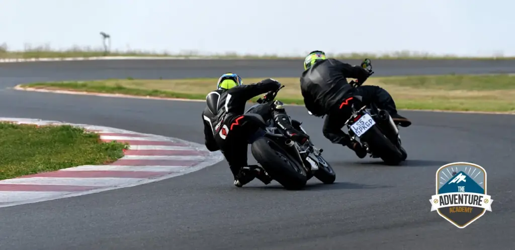Two riders leaning into a corner at Red Star Raceway during Triumph SA rider training