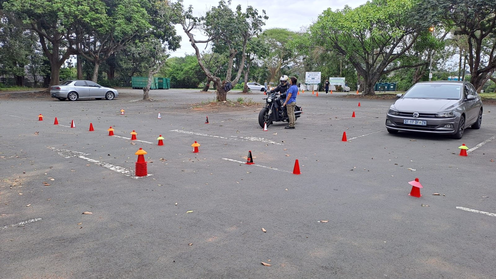 Learner and instructor among training cones at the Ubuntu Motorcycle Training School practice area in Westville
