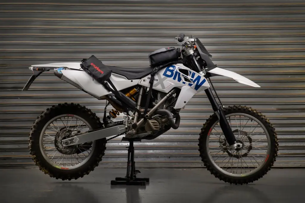 White BMW enduro bike fitted with Turkana Gear bags on a stand